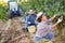 Young woman winemaker picking harvest of grapes in vineyard