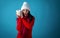 Young woman in winter clothes with a piggy bank