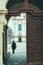 Young woman in winter clothes walks her dog inside Strahov Monastery