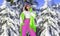 Young woman winter portrait. Winter fashion model with ski suit and goggles. Attractive young woman in wintertime outdoor.