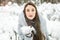 Young woman winter portrait. Winter woman Blowing Snow in forest