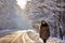 Young woman on a winter walk. Sunny winter day