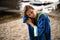 Young woman wipe her hair with towel on background of sandy river pier