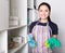 Young woman wiping shelves