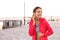 Young woman with wireless headphones listening to music outdoors