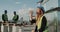 Young woman worker from construction site in hot work day have a little break drinking water , background builders have