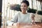 Young woman working at creative stylish office sitting drinking