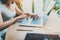 Young woman working at home on modern computer.Girl typing on laptop keyboard sitting at the wooden table.Concept of