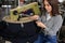 young woman working with linking machine for knitting in textile industry