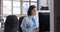 young woman working in the office and talking on a computer headset with colleagues