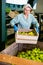 Young woman working on sorting line at fruit warehouse, stacking boxes with selected apples