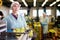 Young woman working on sorting line at fruit warehouse, stacking boxes with selected apples