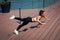 Young woman workout on strainght and muscular build outdoor in t