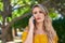 Young woman worried talking on the smartphone at park