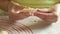 Young woman wrapping up cottage cheese in dough making dumpling 4K close-up