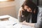 Young woman with writer\'s block sitting at desk