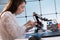 A young woman writes an algorithm for the robot arm. Science Research Laboratory for Robotic Arm Model. Computer Laboratory