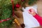 Young woman writes a New Year\'s greeting card or Christmas wish sheet on a white piece of paper