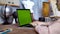 Young woman writing a text on her laptop with green screen. Stock footage. Young female employee engaged in creative