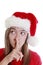 Young woman with xmas hat signalling silence