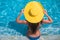 Young woman in yellow hat relaxing at swimming