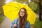 Young woman with yellow umbrella