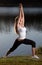 Young woman yoga lake