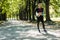 young woman with yoga mat in park ready