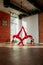 Young womans doing beautiful pair asana Eka pada urdhva dhanurasana in a spacious yoga studio.