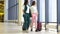 Young women with baggage in international airport walking with her luggage. Airline passengers in an airport lounge