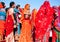 Young women in beautiful colorful sari clothing meeting in crowd on the Desert Festival