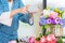 young women business owner florist taking photo Artificial flowers vest with smart phone in her own shop for promote