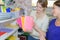 Young women choosing copy-books for writing in stationary shop