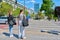 Young women cross the road at pedestrian crossing, in modern European city