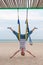 Young women doing aerial yoga asanas or antigravity Yoga indoor. Flying, fitness, stretch, balance, exercise and healthy