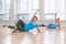 Young women doing workout in gym class indoors to loose weight