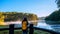 Young women Enjoying tourism take pictures nature, watching the beautiful lake in Thailand