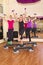 Young women exercising aerobics in gym