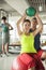 Young women exercising with her personal trainer in the gym