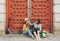 Young women gay couple looking and smiling each other in a red door background. Same sex happiness and joyful concept