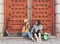 Young women gay couple looking and smiling each other in a red door background. Same sex happiness and joyful concept