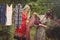 Young women hanging clothes after washing in the courtyard in th