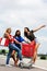 Young women having fun on a shopping cart in the city.