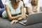 Young women laying while using laptop