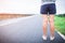 Young women legs and shoes standing on street