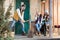 Young women looking at handsome man chopping firewood on porch