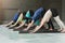 Young women and men in yoga class, doing stretching exercises