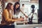 Young women in office working together on desktop