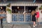 Young women order drinks at bar in urban style decoration