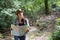 Young women people Hiking with friends backpacks walking together and looking map and taking photo camera by the road and looking